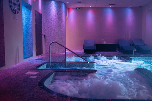 A hydrotherapy pool with loungers and calm lights