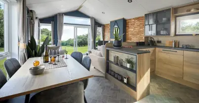 Open plan kitchen diner looking through to lounge with open windows