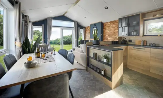 Open plan kitchen diner looking through to lounge with open windows