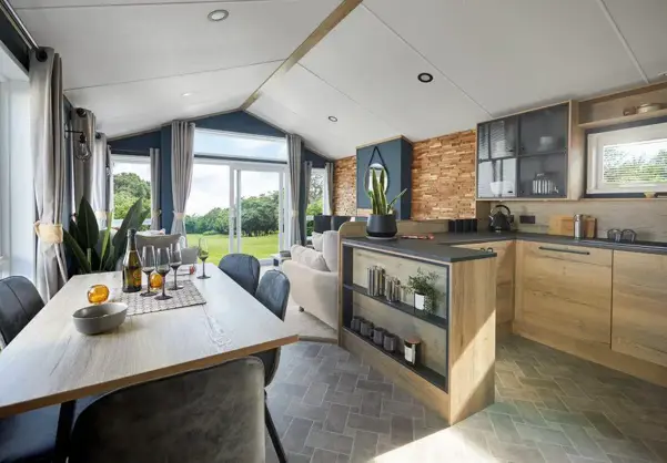 Open plan kitchen diner looking through to lounge with open windows