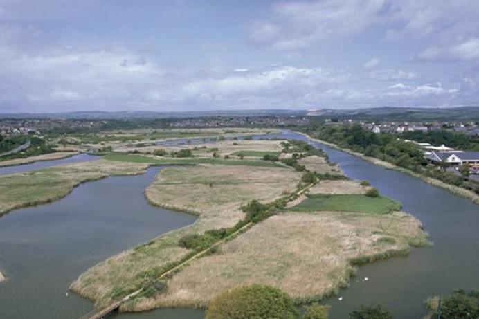 A large body of water surrounded by countryside as seen from above