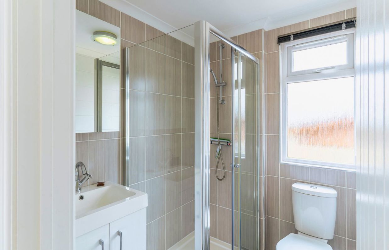 Internal of a lodge bathroom with shower, toilet and sink