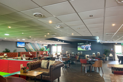 Family Room at Stargazy Bar & Grill with chairs & tables and TVs