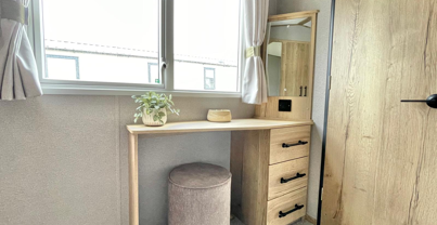 Internal of a caravan master bedroom with dressing area