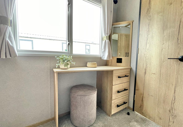 Internal of a caravan master bedroom with dressing area