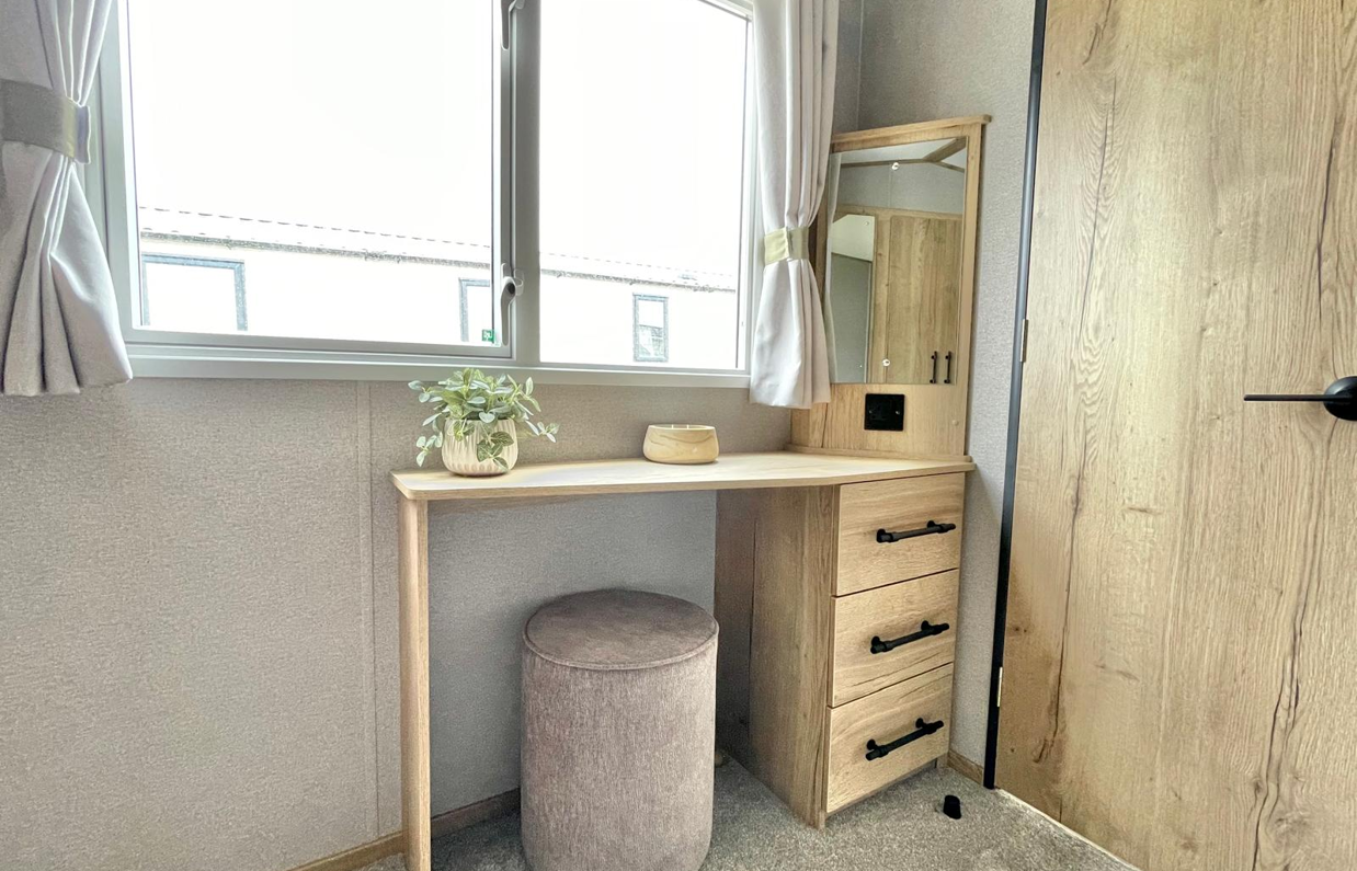 Internal of a caravan master bedroom with dressing area