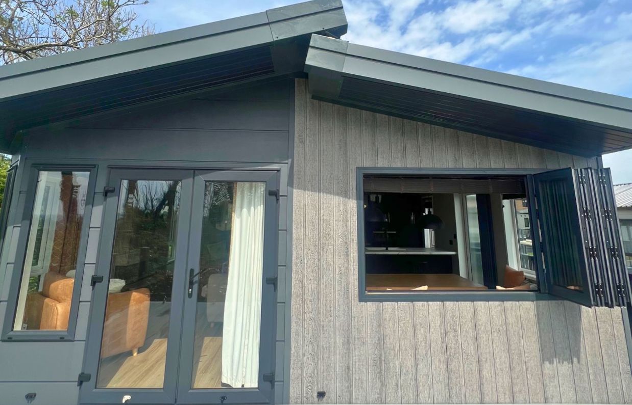 External of a lodge on pitch with decking and sliding windows