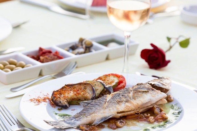 A Fish Dish with Wine and Appetisers 