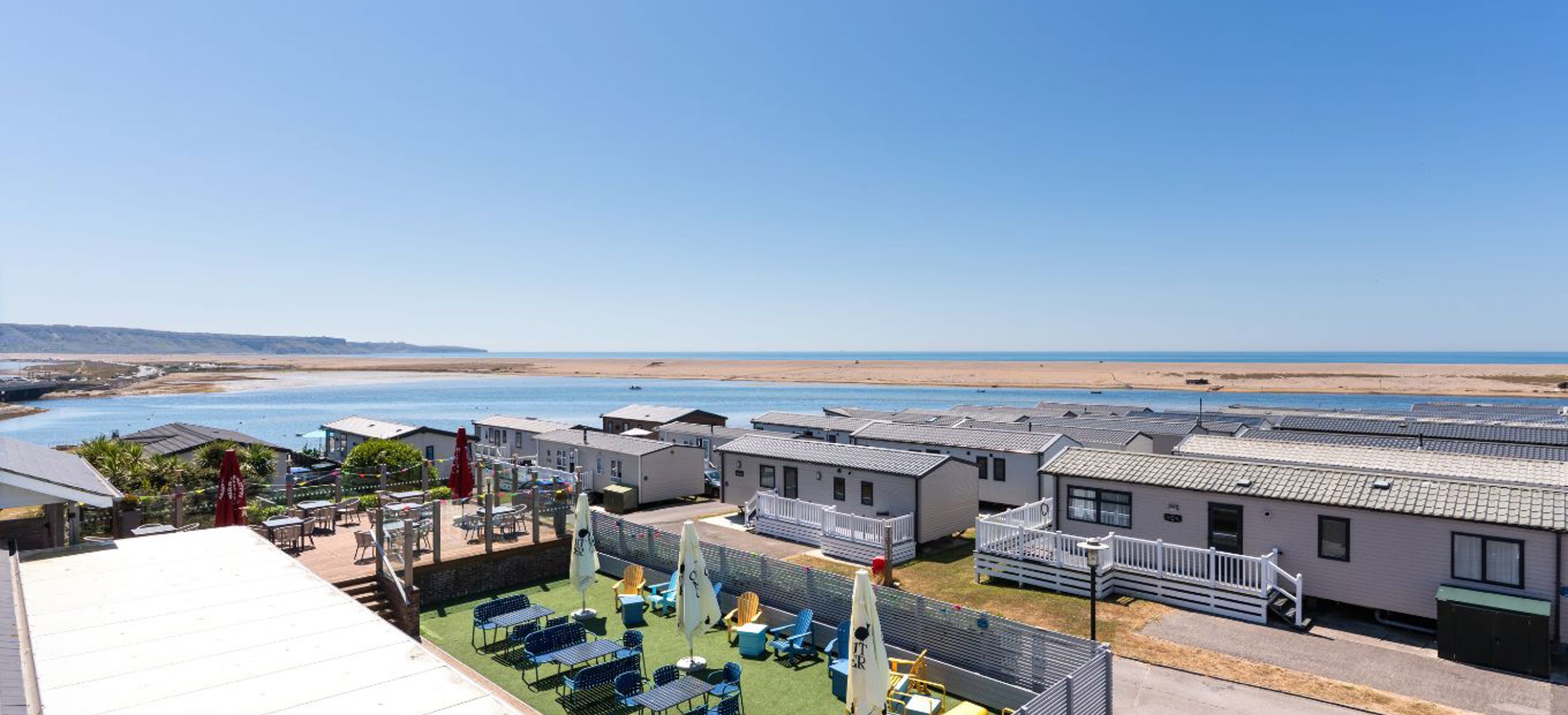 Striking sea views of the Jurassic Coast from Chesil Beach apartments with Breeze Bar & Grill Terrace in foreground