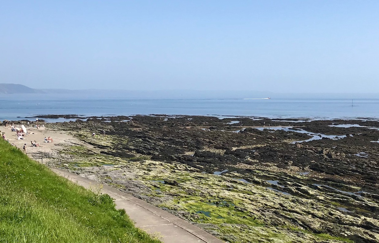 A small rocky beach with views out to sea