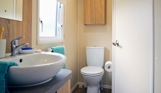 Internal of a caravan bathroom with toilet and sink