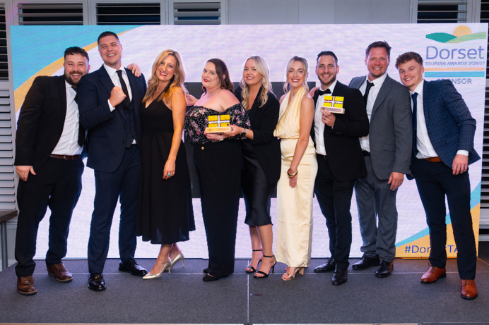 A group of people smiling with awards