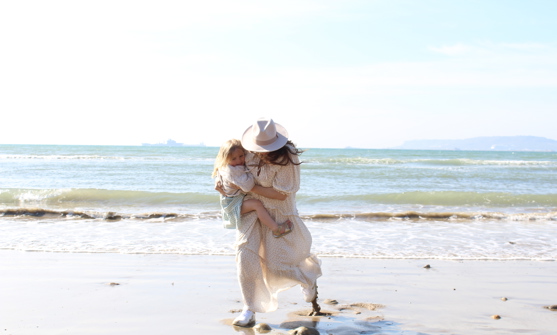 mother and daughter playing on beach