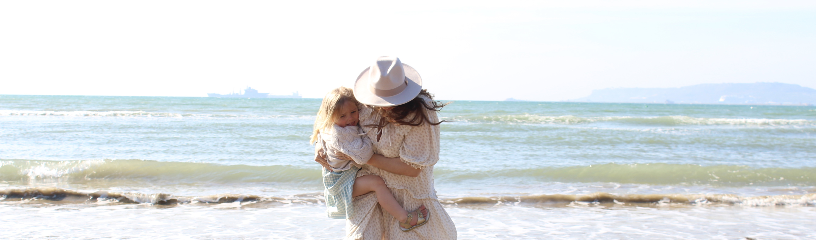 mother and daughter playing on beach