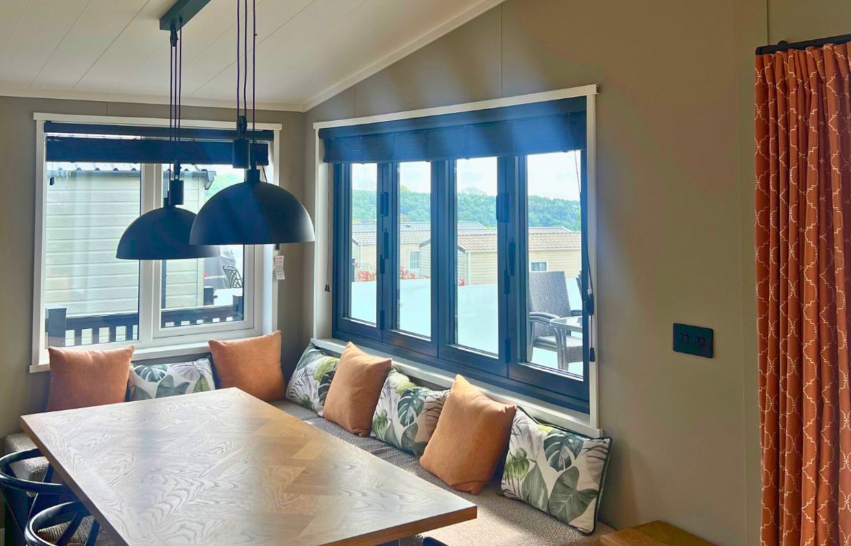 Internal of a lodge open plan dining area with bench seating and sliding windows