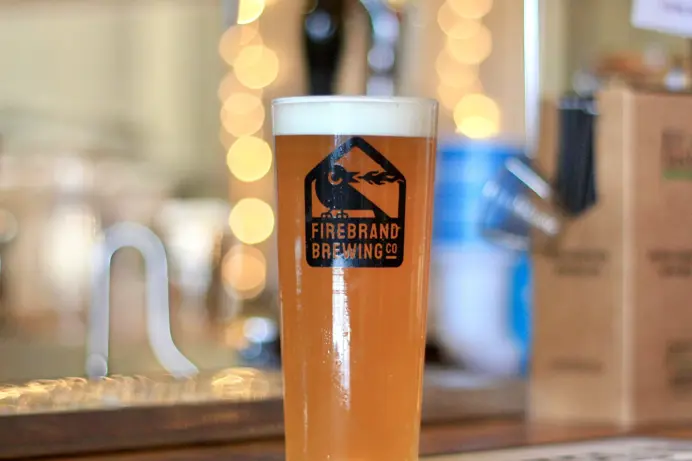 A pint in a glass on a bar