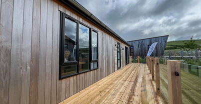 External of a luxury lodge on pitch with decking
