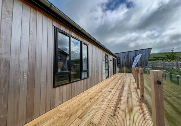 External of a luxury lodge on pitch with decking