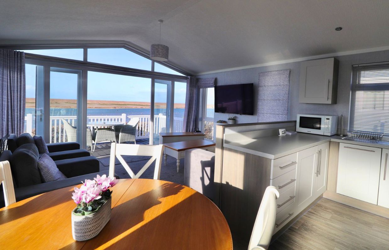 Internal of a caravan open plan living space with seaviews