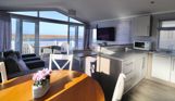 Internal of a caravan open plan living space with seaviews