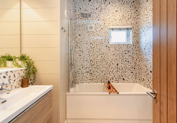 Internal of a luxury lodge bathroom with sink and shower over bath