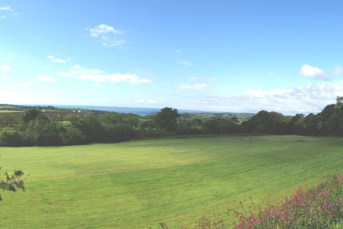 Views of the sea and coast from a golf course