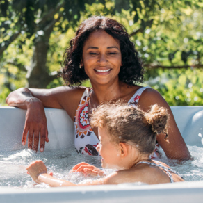 Family relaxing in hot tub on their decking together