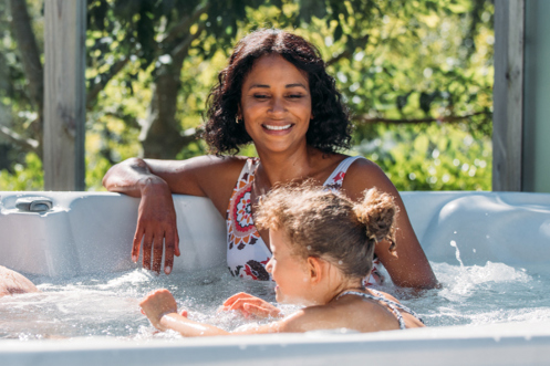 Family relaxing in hot tub on their decking together