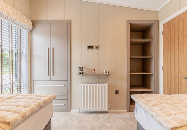 Internal of a luxury lodge twin bedroom with storage
