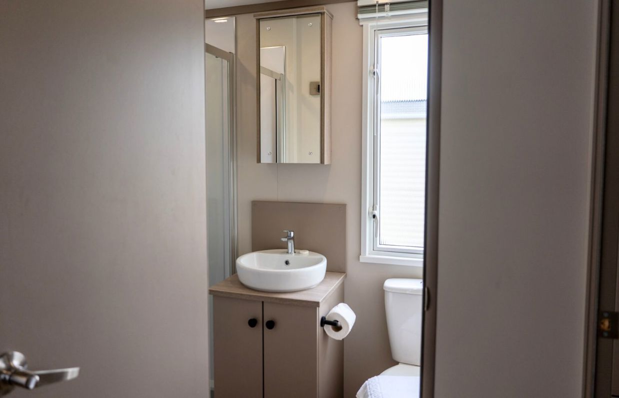 Internal of a caravan bathroom with shower, toilet and sink