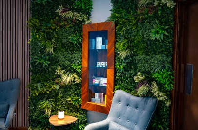 A peaceful spa waiting room with comfy chairs, products and cosy decór