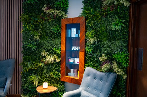 A peaceful spa waiting room with comfy chairs, products and cosy decór