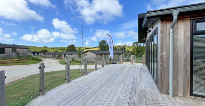 External of a luxury lodge on pitch with expansive decking