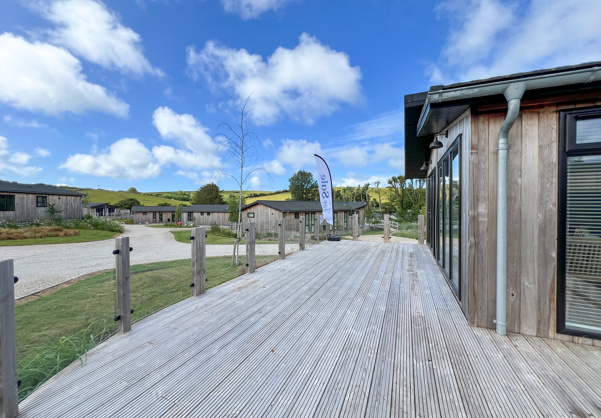External of a luxury lodge on pitch with expansive decking