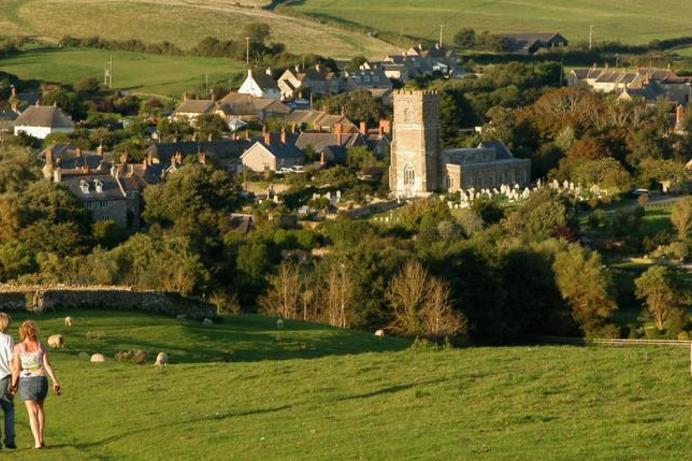 A small quaint classic British village among countryside, rolling hills, old buildings and wildlife