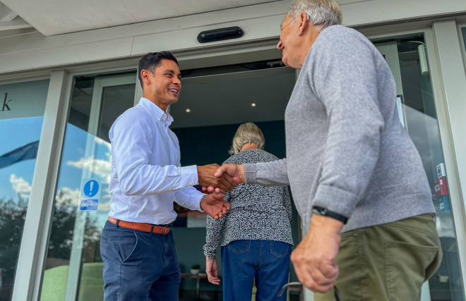 Man being greeted by Sales Team Member