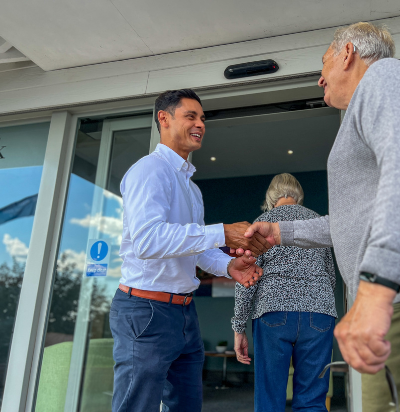 Man being greeted by Sales Team Member