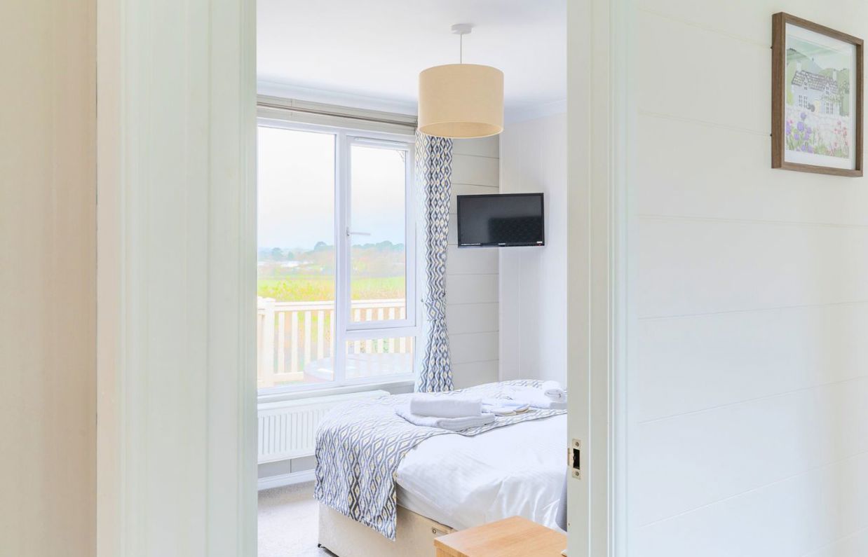 Internal of a lodge master bedroom with countryside views