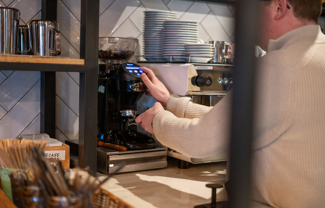 A man making fresh barista coffee in Breeze Bar & Grill
