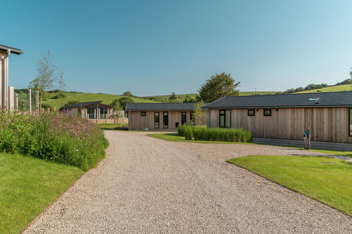 Luxury lodges among woodland and rolling hills at The Stables at Bowleaze Cove Holiday Park & Spa