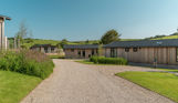 Luxury lodges among woodland and rolling hills at The Stables at Bowleaze Cove Holiday Park & Spa