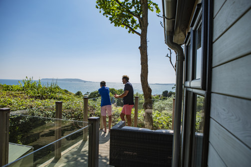 Father and son enjoy the view from their lodge
