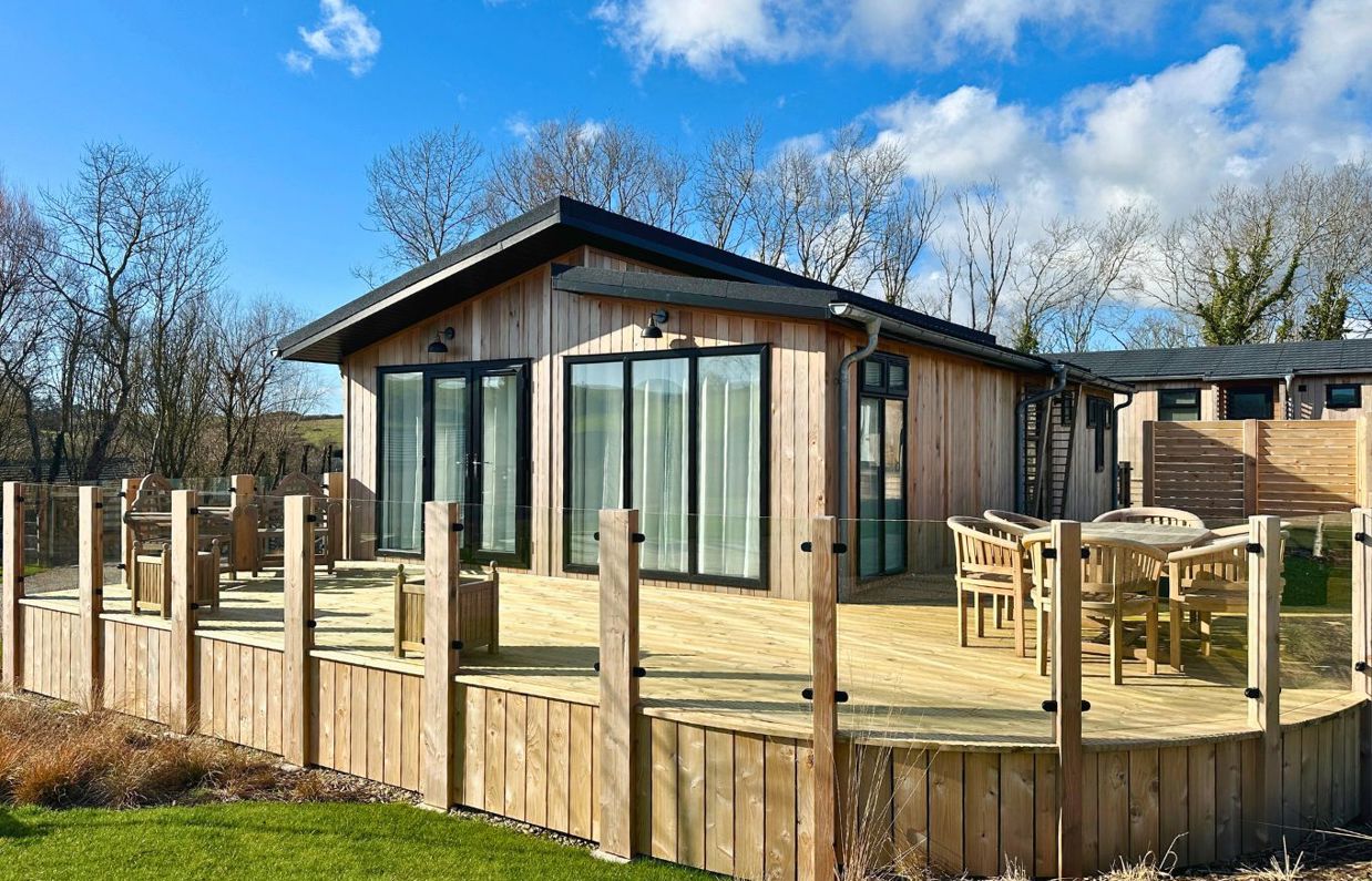 External of a luxury lodge decking with outdoor furniture