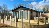 External of a luxury lodge decking with outdoor furniture