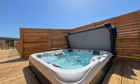 External of a luxury lodge with decking and hot tub