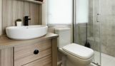 Internal of a caravan bathroom with toilet and sink