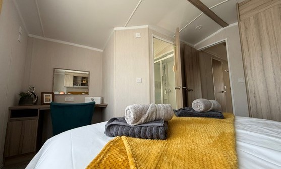 Internal of a caravan double bedroom with dressing area and ensuite