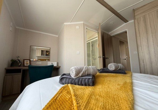 Internal of a caravan double bedroom with dressing area and ensuite