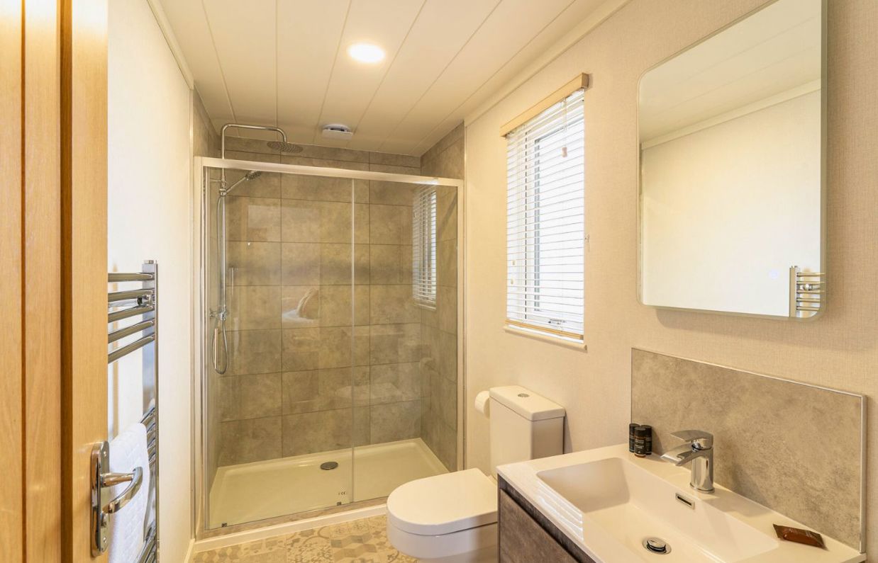 Internal of a luxury lodge bathroom with shower, toilet and sink