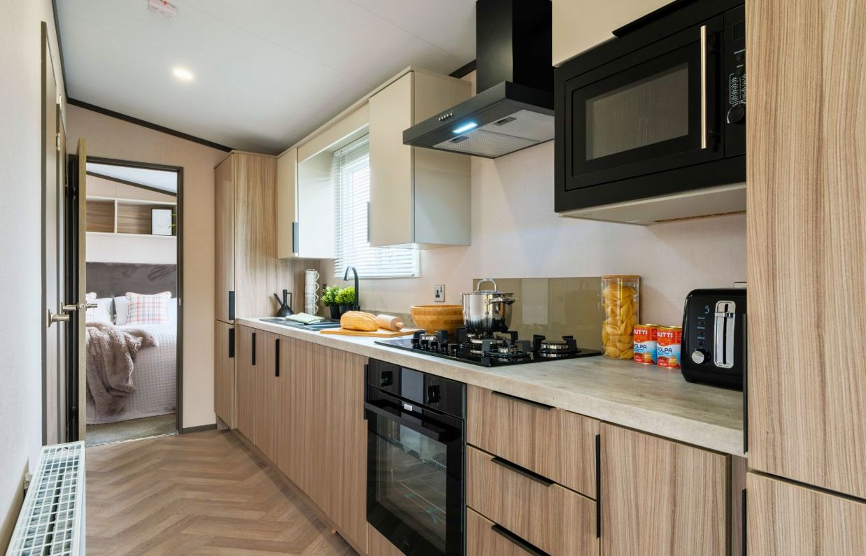 Internal of a caravan open plan kitchen adjacent to bedroom